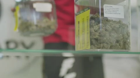 Man Picking Up Weed Jar (Marijuana Cannabis Bud Plant) OK Dispensary 4k - KOMODO Video stock 219630144
