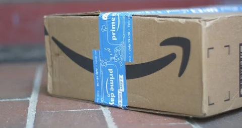 Man Picks Up Amazon Prime Package from Porch Stock Footage 113284731