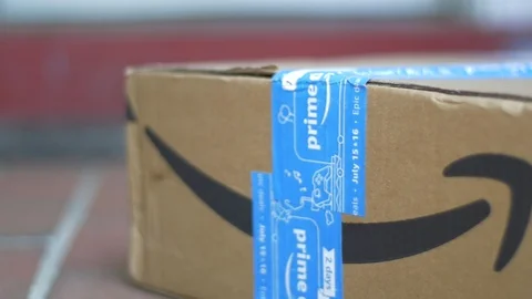 Man Picks up Amazon Prime Package Stock Footage 113284888