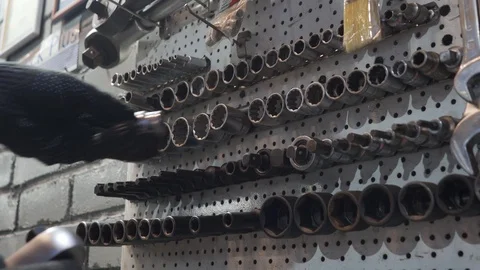 Man picks up bits for wrench Stock Footage 102867387