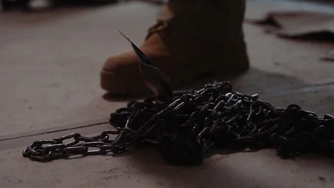 A Man Picks Up A Chain Stock Footage 87481295