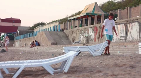 Man picks up chairs Stock Footage 8539740