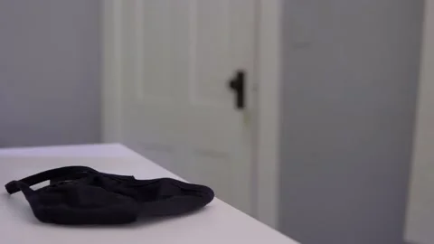 Man picks up Cloth Face Mask off Desk Stock Footage 138772802