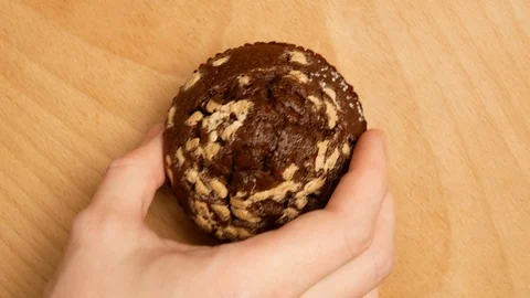 Man picks up a cupcake from the table. Stock Footage 107730207