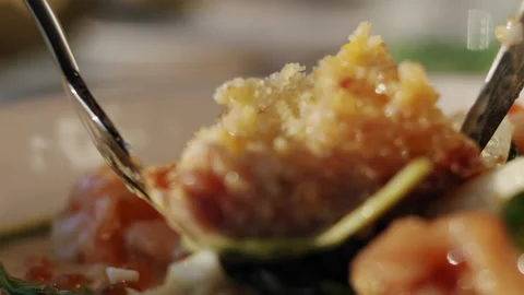A man picks with a fork knife pieces of salmon with spinach and brioche bun 스톡 동영상 151297164