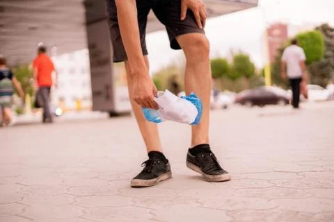 Man picks the garbage plastic and paper in the city street. clean environment Stock Photos