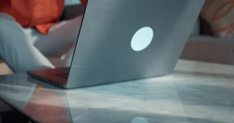 Man picks up glasses from table, opens his laptop, starts working. Technology Stock Footage 263519319