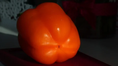 A man picks up a knife, and cuts sweet pepper. Pepper fresh, juicy, orange. S Stock Footage 109421375