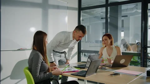 A man picks up a laptop during the end of the meeting Stock Footage 257424017
