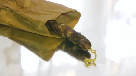 A man picks up from mirrored table stick sausages, close-up Stock Footage 67719419