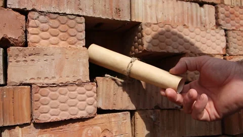 Man picks up an old letter that lay between the red bricks. Stock Footage 254982113