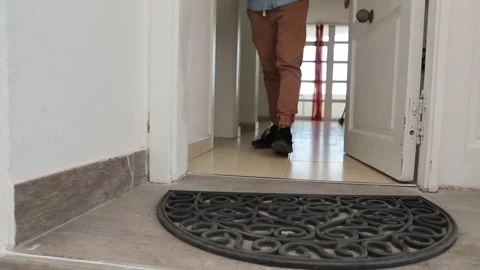 A man picks up a parcel delivered in front of his door, online shopping 库存影片 219580294