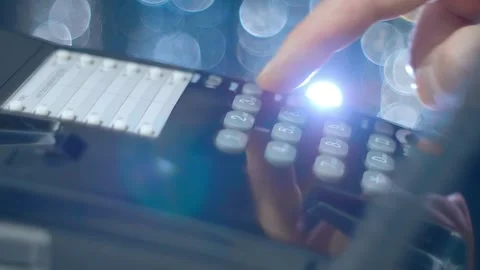 A man picks up the phone, dials a number on a push-button wired black telephone 動画素材 259683108