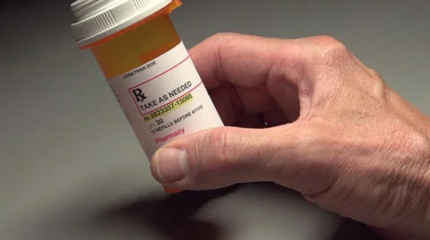 Man picks up a pill bottle Stock-Footage 24706405