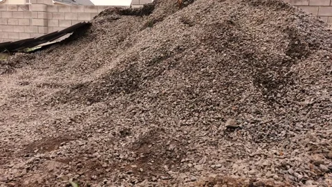 A man picks up rubble in a bucket Video stock 132778395