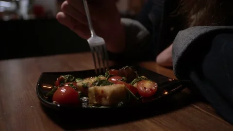 A man picks at a salad Stock Footage 223881829