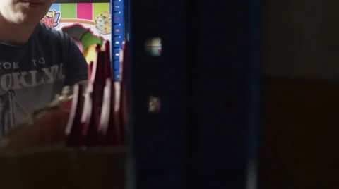 Man Picks a Set of Paintbrushes from a Shelf Stock Footage 62680092