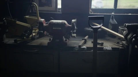 Man picks up a shovel in a workshop 1 Stock Footage 81496426