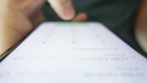 A man picks up a smartphone from the table, turns it on and dials a phone number Vidéo 225763799