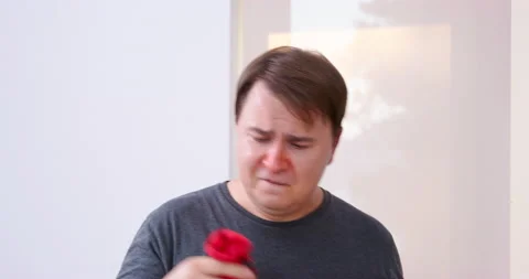 Man picks up socks of different colors from floor, looking for. Storage space Stock Footage 207601223