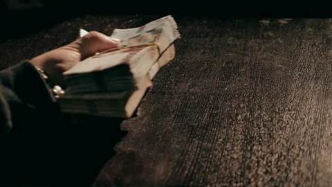 The man picks up a stack of banknotes Stock Footage 284443637
