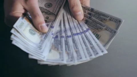 The man picks up a stack of banknotes 스톡 동영상 284444082