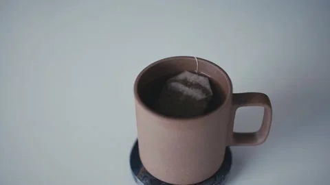 Man picks up steaming cup of tea Video stock 165767008