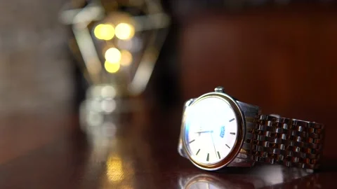 The man picks up a wristwatch from the table Video stock 170818021