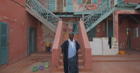 Man pictured in front of his house, Goree, Senegal (4K) Stock Footage 47942939
