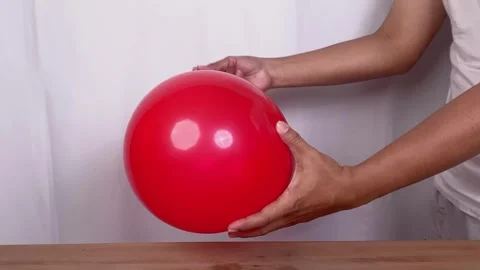 Man pierces a balloon with a needle Stock-Footage 345587536