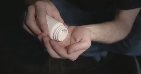 Man with pills sitting on the floor Stock Footage 168458238