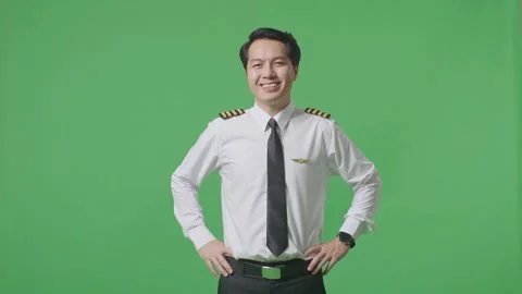 Man Pilot With Arms Akimbo Looking At Camera And Smiling Standing Green Screen Stock Footage 244393496