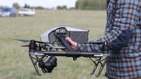 Man pilot checking quadcopter drone before aerial flight and filming. Stock Footage 161483241