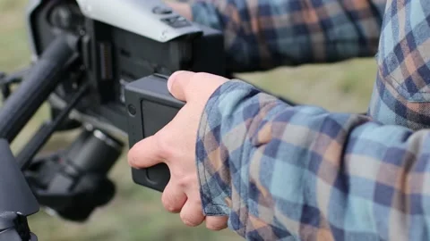 Man pilot checking quadcopter drone before aerial flight and filming. Stock Footage 165539432
