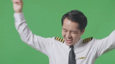 Man Pilot Dancing And Celebrating While Standing In The Green Screen Background Stock Footage 244398771