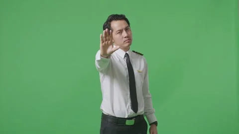 Man Pilot Looking At Camera And Disapproving With No Hand Sign ON Green Screen Stock Footage 244393917