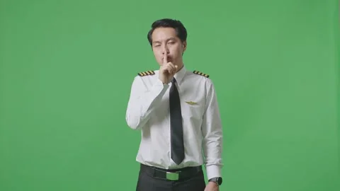 Man Pilot Looking At Camera And Making Shh Gesture In The Green Screen Stock Footage 244393947
