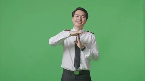 Man Pilot Looking At Camera And Showing Time Out Hands Gesture On Green Screen Stock Footage 244394636