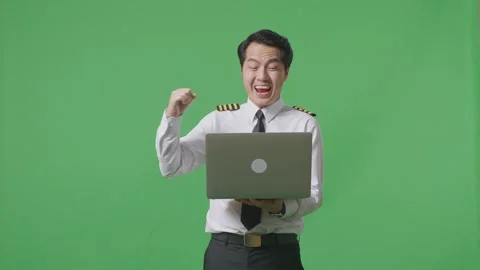 Man Pilot Looking At A Laptop Then Screaming Goal Celebrating ON Green Screen Stock Footage 244394792