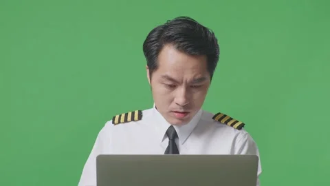 Man Pilot Looking At A Laptop Then Screaming Goal Celebrating ON Green Screen Stock Footage 244398044