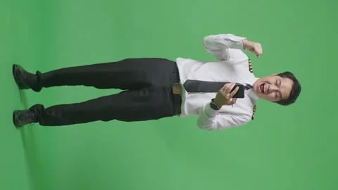 Man Pilot Looking At Smartphone Then Screaming Goal Celebrating On Green Screen Stock Footage 244400144