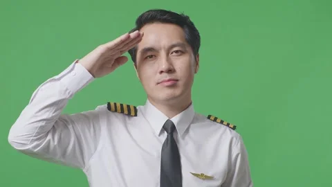Man Pilot Is Respectful, Saluting While Standing In The Green Screen Background Stock Footage 244398614