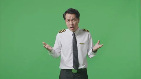 Man Pilot Saying Why And Standing Doubtfully In The Green Screen Background Stock Footage 244394381