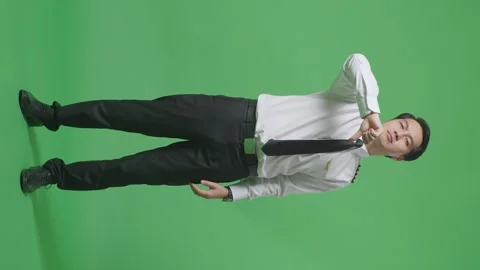 Man Pilot Showing Thumbs Down Gesture To Camera While Standing On Green Screen Stock Footage 244399142