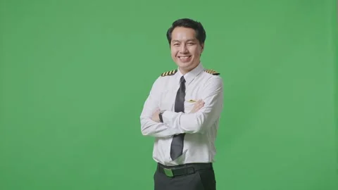 Man Pilot Smiling And Crossing His Arms To Camera While Standing On Green Screen Stock Footage 244394059
