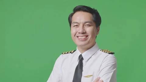 Man Pilot Smiling And Crossing His Arms To Camera While Standing On Green Screen Stock Footage 244396827