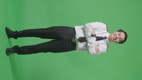 Man Pilot Smiling And Crossing His Arms To Camera While Standing On Green Screen Stock Footage 244400096
