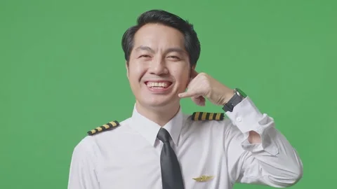 Man Pilot Smiling And Making Call Me Gesture To Camera Standing On Green Screen Stock Footage 244396036