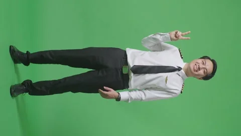 Man Pilot Smiling And Making Call Me Gesture To Camera Standing On Green Screen Stock Footage 244399233