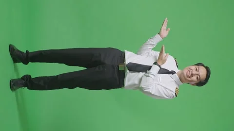 Man Pilot Smiling And Pointing To Side While Standing In The Green Screen Stock Footage 244400080